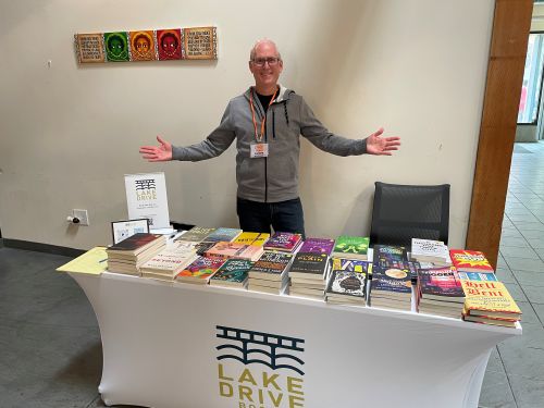 David Morris, publisher of Lake Drive Books, at the Lake Drive Book table at a conference